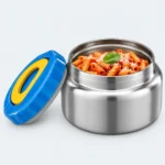 Mini pot isotherme inox ouvert rempli de pâtes à la tomate, couvercle bleu posé à côté